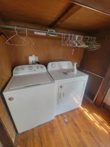 a washer and dryer sitting in a small room at Cozy Apartment in Historic East Knoxville in Knoxville