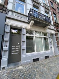 a building with a black door and a balcony at Sweet Home in Liège