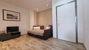 a bedroom with a bed and a flat screen tv at Casa Lina Tirano in Tirano