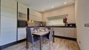 a kitchen with a table and chairs in a kitchen at Casa Lina Tirano in Tirano +31 photos