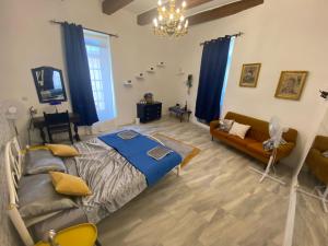 a living room with a bed and a couch at Maleth House in Naxxar