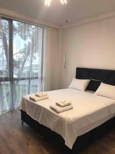 a bedroom with a large bed with two towels on it at Sun Beach Hotel Grigoleti in Grigoleti +22 photos