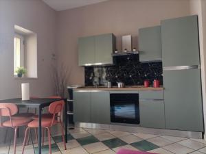 a kitchen with a table and a refrigerator at B&B Marilyn house in Caserta