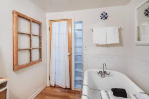 een witte badkamer met een bad en een raam bij Alpine Cottage Hideaway in Stateline +40 foto's