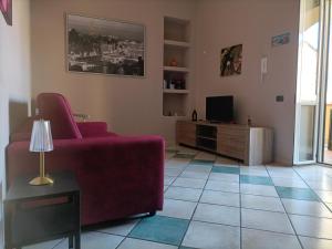a living room with a couch and a tv at B&B merilyn house in Caserta