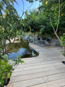 a wooden bridge over a pond in a garden at La Maison Du Soleil in La Garde-Freinet