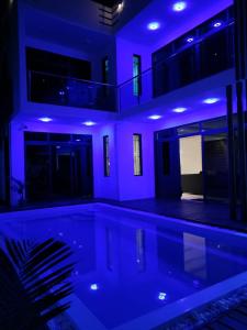 a swimming pool in a house with blue lights at SRG Villa in Grand Baie