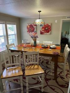 a dining room with a wooden table and chairs at Adventure Launch Pad in Asheville +18 photos