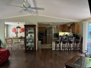 a living room and kitchen with a ceiling fan at Adventure Launch Pad in Asheville