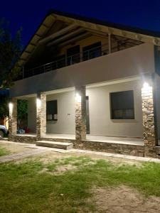 a house with lights on it at night at Coastal vista retreat 2 in Neos Panteleimonas