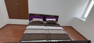 a small bed in a room with at Double Gates Apartment in Baku