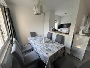 a table and chairs with a table and a kitchen at HANNA Apartment in Interlaken