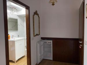 a bathroom with a sink and a mirror at Yuri Guest House in Gjirokastër