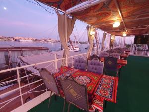 a boat with two chairs on the deck of a boat at Moon Boat in Luxor