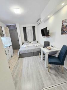 a bedroom with a bed and a table and a tv at Cube Gray in Mostar