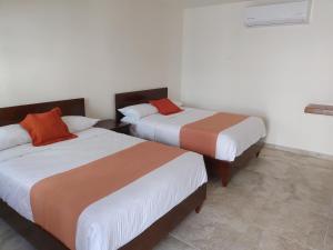 Postel nebo postele na pokoji v ubytování Hotel Lorimar