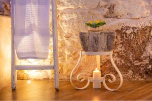 a candle sitting on a chair with a plant at Alloggio Turistico Suite Nino in Ceglie Messapica