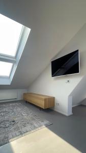Μια τηλεόραση ή/και κέντρο ψυχαγωγίας στο Maisonette-Loft: 4 Schlafzimmer