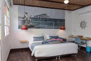 a bedroom with a bed with a picture on the wall at Placita Vieja Hotel Boutique Spa in Santa Marta