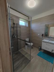 a bathroom with a shower and a toilet and a sink at Pohoda Stay in Revúca