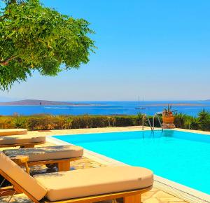 a swimming pool with a view of the ocean at Paros Afrodite Luxury Villas in Aliki