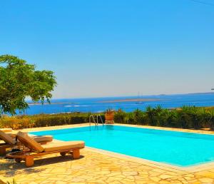 a swimming pool with a view of the ocean at Paros Afrodite Luxury Villas in Aliki