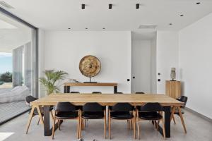 a dining room with a wooden table and chairs at Villa Y in Vence