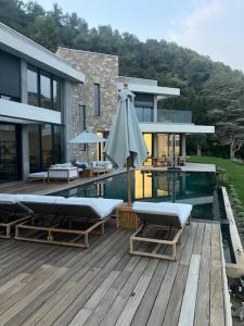 a deck with an umbrella and a swimming pool at Villa Y in Vence