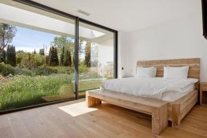 a bedroom with a bed and a large window at Villa Y in Vence +28 photos