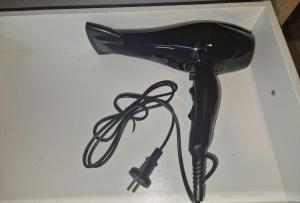 a black blow dryer sitting on a white box at Laubach Apartments in Laubach