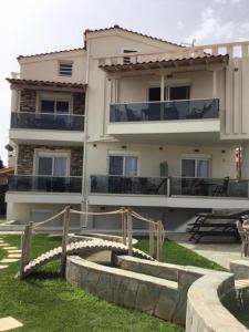 a large building with balconies on the side of it at Villa Nikiti View semi-basement in Nikiti
