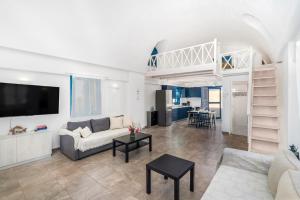 a living room with a couch and a loft at Electra Residence in Oia