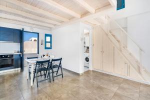a kitchen and dining room with a table and chairs at Electra Residence in Oia