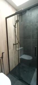 a bathroom with a glass shower with a toilet at Maison atypique O'ZEN à 5 min de La Rochelle in Saint-Xandre +7 photos