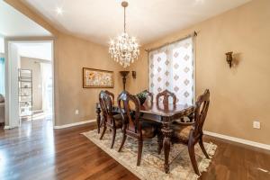 a dining room with a table and chairs and a chandelier at 4br Near Hilton Falls - Kelso - Gazebo, Workspace in Milton