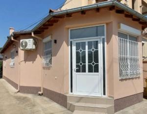 a small house with a door and a window at Knezevic House in Gevgelija