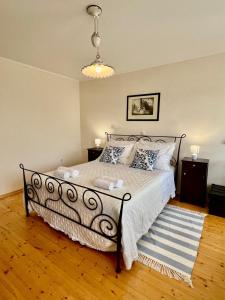 a bedroom with a large bed with white sheets and pillows at Ciborovi Dvori in Bribir +56 photos
