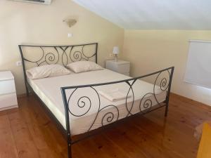a bedroom with a bed with a black and white bed frame at Sabbia Village in Agia Anna +29 photos