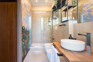 a bathroom with a sink and a toilet and a shower at Terra dell'Etna in Catania