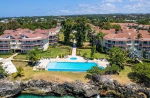 an aerial view of a resort with a swimming pool at Hispaniola Beach Condo 9a2oceanviewbeachpool in Sosúa