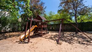 a playground with a slide in the sand at Hispaniola Beach Condo 9a2oceanviewbeachpool in Sosúa