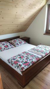 a bedroom with two beds in a attic at Domek Pod Lasem in Lipowa