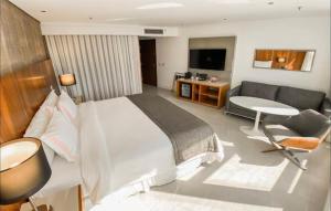 a bedroom with a large bed and a couch at Hotel Nacional in Rio de Janeiro