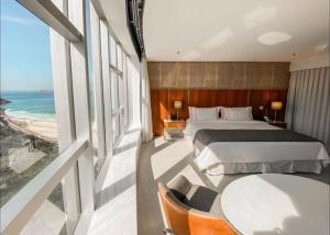 a bedroom with a bed and a view of the ocean at Hotel Nacional in Rio de Janeiro
