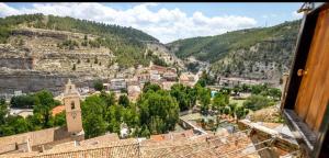 a view from a window of a town with a mountain at Loft Medieval Del Júcar in Alcalá del Júcar
