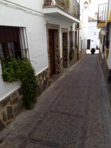an empty street in a town with buildings at Casa Rural Majaceite in El Bosque