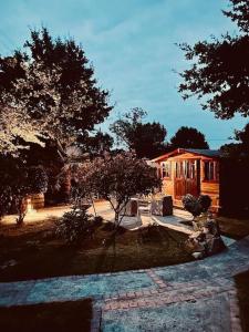 a house with a tree in front of it at Chalet dans notre jardin in Parigné +12 photos