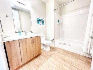 a bathroom with a sink and a toilet and a tub at The Traveler's Getaway in San Diego +7 photos