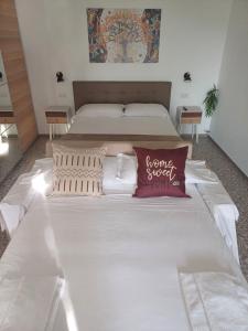 a bedroom with two beds and a pillow that says some sweet wife at La Casa di Pitti in Anacapri