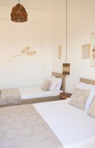 Ένα ή περισσότερα κρεβάτια σε δωμάτιο στο Alfa Home Naousa Paros Seaview